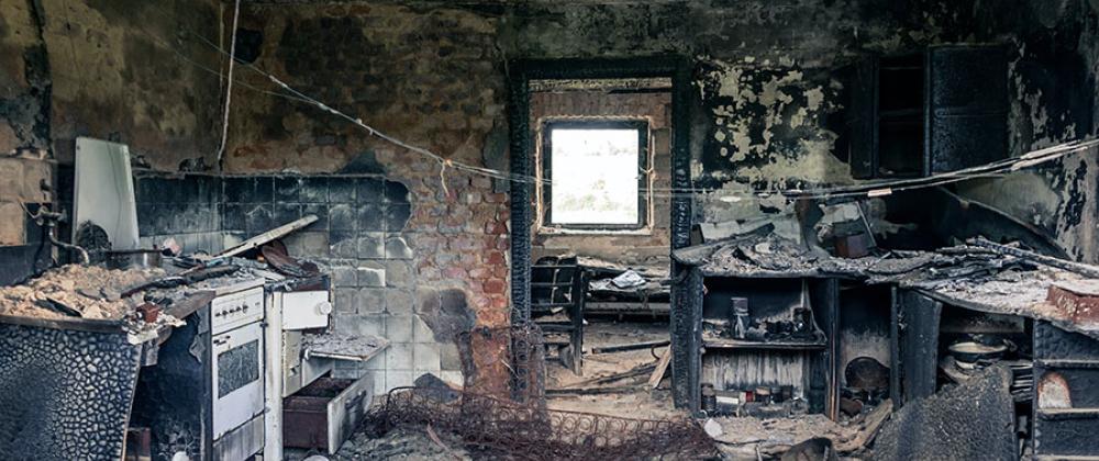 A picture of a kitchen with fire damage