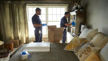 Two men removing items after fire damage