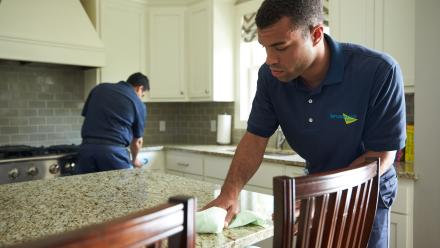 Two men cleaning up kitchen