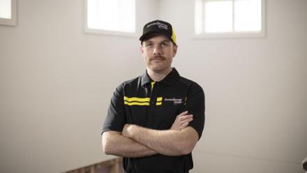 worker standing with arms crossed