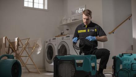 technician with dehumidifier
