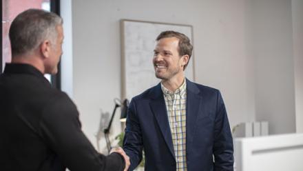 franchisee and agent shaking hands