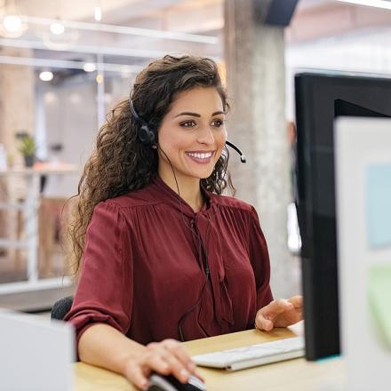 A customer support specialist sitting at her desk
