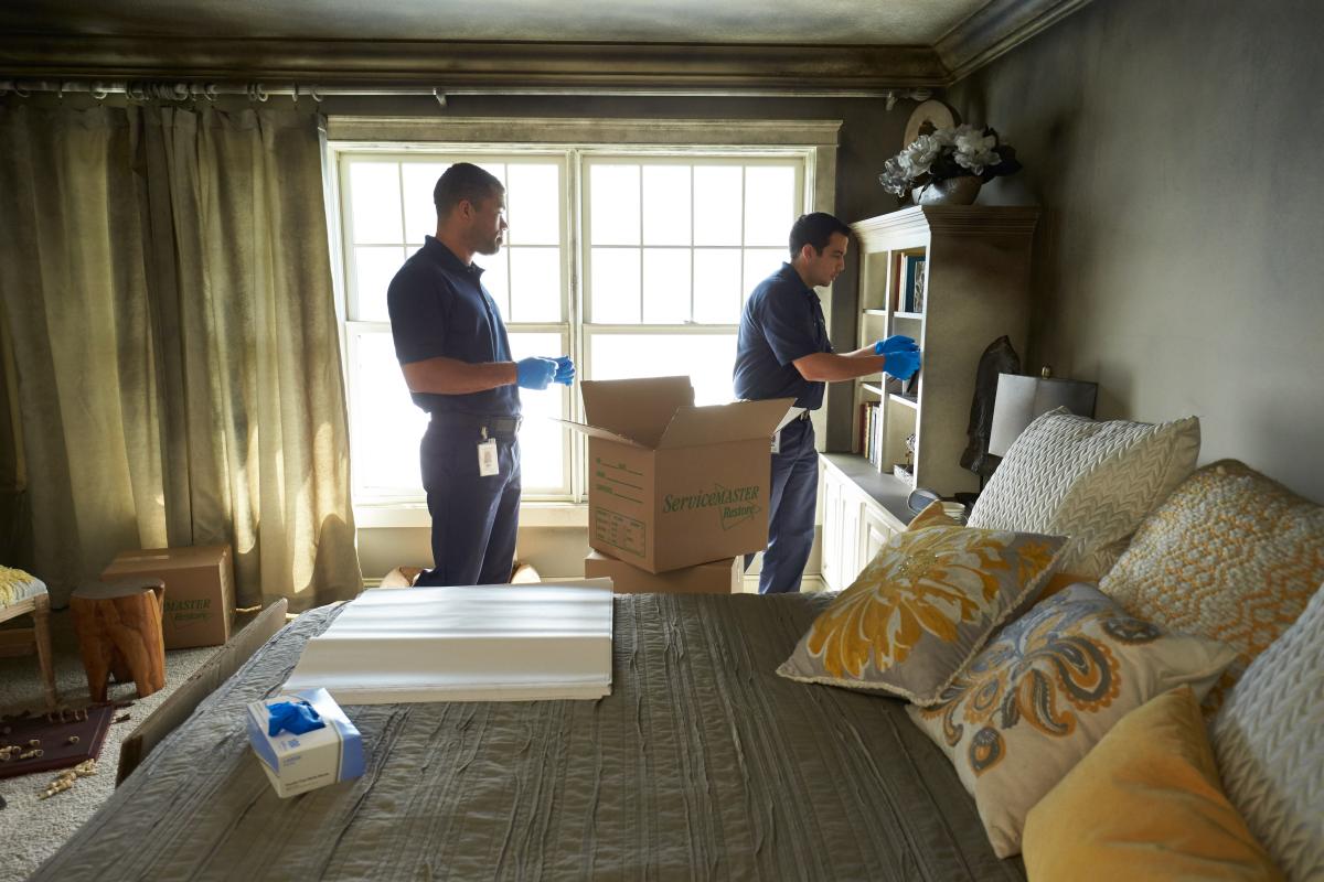 Two men removing items after fire damage
