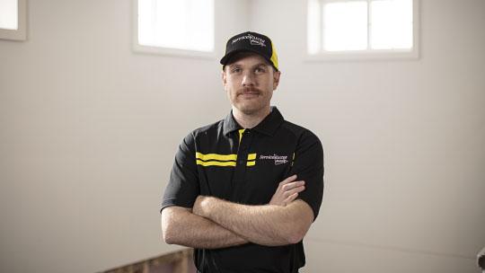 worker standing with arms crossed