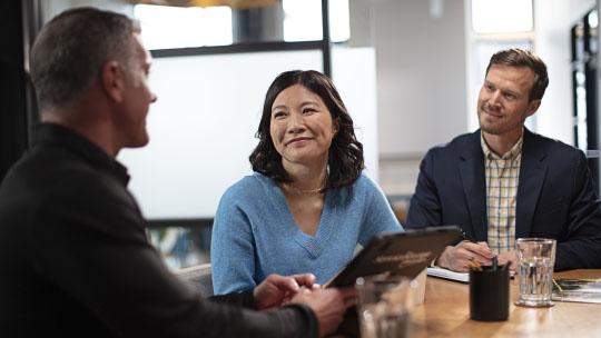 three people in a meeting 