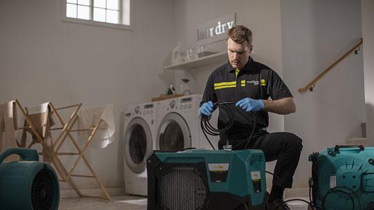 technician with dehumidifier