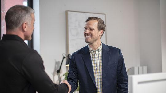 franchisee and agent shaking hands