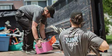 Junk removal team loading truck