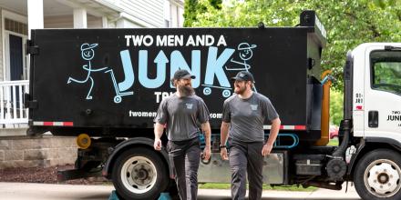 Junk haulers walking near their junk truck