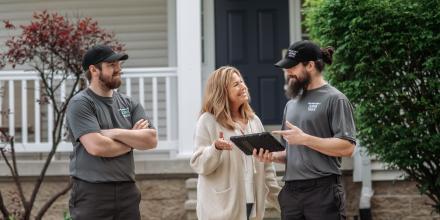 Happy customer talking to a junk hauler during her junk removal service