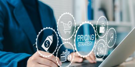 Pricing strategy icons shows from computer screen as someone writes