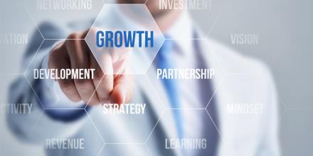 Man pointing to growth text on screen