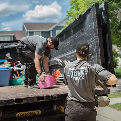 Junk removal team loading truck