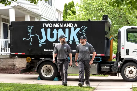 Junk haulers walking near their junk truck