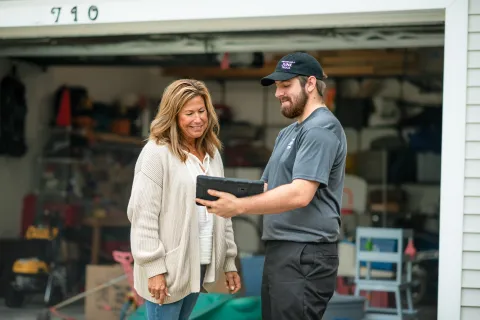 Happy customer talking to a junk hauler during her junk removal service
